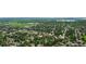 Beautiful aerial view of a tree-lined neighborhood with a nearby lake and school at 3317 W Belmont Ave, Littleton, CO 80123
