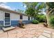 Inviting backyard patio with stone paving, grill, and lush greenery, perfect for outdoor entertaining at 3317 W Belmont Ave, Littleton, CO 80123