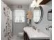 Bathroom with a vanity, oval mirror, and a shower with a floral curtain at 3317 W Belmont Ave, Littleton, CO 80123