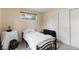 Cozy bedroom featuring a comfortable bed, natural light from window, and closet space at 3317 W Belmont Ave, Littleton, CO 80123