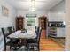 Cozy dining room featuring wood flooring and view to kitchen at 3317 W Belmont Ave, Littleton, CO 80123