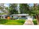 Cozy home with manicured lawn, flowerbeds, and a convenient attached garage at 3317 W Belmont Ave, Littleton, CO 80123