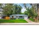 Charming single-story home featuring a well-maintained lawn and an attached garage at 3317 W Belmont Ave, Littleton, CO 80123