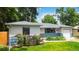 Charming ranch style home featuring a manicured lawn and flower beds at 3317 W Belmont Ave, Littleton, CO 80123