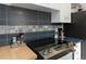 Modern kitchen with sleek countertops, tiled backsplash, and stainless steel stove at 3317 W Belmont Ave, Littleton, CO 80123