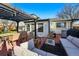 Inviting backyard featuring a pergola with dining and seating, perfect for relaxation and entertaining at 6787 E Exposition Ave, Denver, CO 80224