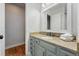 Bathroom featuring granite countertop with under-sink storage, a white sink, and a large mirror at 6787 E Exposition Ave, Denver, CO 80224