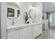 A modern bathroom featuring a dual sink vanity with white countertops and brushed nickel fixtures at 6787 E Exposition Ave, Denver, CO 80224