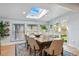 Dining room with a skylight, large table, backyard views, and sliding glass door to the outside at 6787 E Exposition Ave, Denver, CO 80224