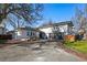 Charming multi-level home featuring modern architecture, attached garage, and an inviting front porch at 6787 E Exposition Ave, Denver, CO 80224