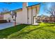 Backyard featuring a well-maintained lawn, basketball hoop, patio area, and stylish home exterior at 6787 E Exposition Ave, Denver, CO 80224