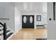 Bright foyer featuring hardwood floors, double front doors, staircase, and bench seating near a bay window at 6787 E Exposition Ave, Denver, CO 80224