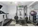 Home gym featuring weight lifting equipment and a treadmill in a well-lit space at 6787 E Exposition Ave, Denver, CO 80224