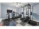 Home gym equipped with weight lifting equipment, a treadmill, and exercise bike for a complete workout at 6787 E Exposition Ave, Denver, CO 80224