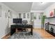 Bright home office with hardwood floors, a sleek black desk, and stylish decor at 6787 E Exposition Ave, Denver, CO 80224