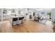 Open kitchen and dining room with hardwood floors, skylight, and views to the backyard at 6787 E Exposition Ave, Denver, CO 80224