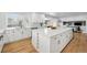 Spacious kitchen featuring an island with wine rack, stainless steel appliances and modern fixtures at 6787 E Exposition Ave, Denver, CO 80224