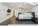 Spacious main bedroom boasting hardwood floors, ample closet space, and a cozy sitting area at 6787 E Exposition Ave, Denver, CO 80224