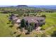 Sprawling ranch-style home with an attached garage, mature landscaping, mountain views, and a detached garage at 3358 Castle Butte Dr, Castle Rock, CO 80109