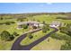 Expansive ranch-style home with a detached garage, a long drive, and mature landscaping on a rolling, green lawn at 3358 Castle Butte Dr, Castle Rock, CO 80109