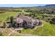 Expansive estate with stone accents, lush landscaping, and breathtaking mountain views from a private hilltop setting at 3358 Castle Butte Dr, Castle Rock, CO 80109