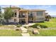 Backyard features a two-story veranda, stone pillars, a spiral staircase, and a hot tub at 3358 Castle Butte Dr, Castle Rock, CO 80109