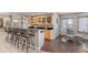 Finished basement bar area featuring custom cabinets, dark countertops, and seating for entertaining at 3358 Castle Butte Dr, Castle Rock, CO 80109