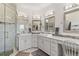 Bright bathroom featuring double vanity, walk-in shower, and modern fixtures at 3358 Castle Butte Dr, Castle Rock, CO 80109