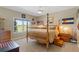 This bright bedroom features a four-poster bed, a large window with scenic views, and patriotic decor at 3358 Castle Butte Dr, Castle Rock, CO 80109