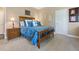 Cozy bedroom featuring a wood frame bed with stylish blue patterned bedding and matching pillows at 3358 Castle Butte Dr, Castle Rock, CO 80109