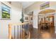 Elegant foyer with hardwood floors, curved staircase, and views into the formal dining room at 3358 Castle Butte Dr, Castle Rock, CO 80109