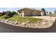 Attached three-car garage with concrete driveway and low maintenance rock landscaping at 3358 Castle Butte Dr, Castle Rock, CO 80109