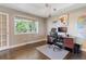 Bright home office featuring a window, modern desk, and hardwood floors at 3358 Castle Butte Dr, Castle Rock, CO 80109