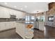 Gourmet kitchen with stainless steel appliances, granite countertops, and a cozy dining nook with stone fireplace at 3358 Castle Butte Dr, Castle Rock, CO 80109