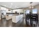 Spacious kitchen with granite countertops, white cabinets, a large island, and stainless steel appliances at 3358 Castle Butte Dr, Castle Rock, CO 80109