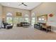 Spacious living room with large windows and comfortable leather seating at 3358 Castle Butte Dr, Castle Rock, CO 80109