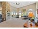 Cozy living room with high ceilings, a stone fireplace, plush seating, and ample natural light at 3358 Castle Butte Dr, Castle Rock, CO 80109