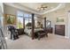 Spacious main bedroom with a four-poster bed and a seating area at 3358 Castle Butte Dr, Castle Rock, CO 80109