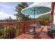 Relaxing deck area with seating and umbrella offering stunning views of the surrounding landscape at 347 Buena Vista Ave, Palmer Lake, CO 80133