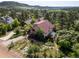Charming two-story home with lush landscaping and a greenhouse in a serene, wooded neighborhood at 347 Buena Vista Ave, Palmer Lake, CO 80133