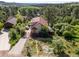 Beautiful exterior featuring a colorful front porch, a greenhouse, and lush landscaping surrounding the home at 347 Buena Vista Ave, Palmer Lake, CO 80133