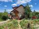 Charming home with a colorful front deck, vibrant garden, and inviting curb appeal at 347 Buena Vista Ave, Palmer Lake, CO 80133