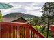 Scenic views from deck overlooking rooftops and mountain landscape on a partly cloudy day at 347 Buena Vista Ave, Palmer Lake, CO 80133