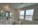 Bright bathroom featuring a double vanity with modern countertops and a soaking tub with modern fixtures at 16529 Black Rose Cir, Parker, CO 80134