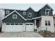 Charming two-story home with a three car garage, stone accents and modern architectural details at 16529 Black Rose Cir, Parker, CO 80134