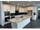 Modern kitchen with marble countertops, stainless steel appliances, large island, and ample cabinet space at 16529 Black Rose Cir, Parker, CO 80134