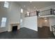 Elegant living room with soaring ceilings, fireplace, and an open layout to the second story at 16529 Black Rose Cir, Parker, CO 80134