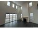 Bright and airy living room featuring large windows, sliding glass doors, and a fireplace at 16529 Black Rose Cir, Parker, CO 80134