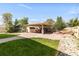 Backyard featuring covered patio, built-in bbq and mature landscaping at 1249 S Irving St, Denver, CO 80219