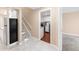 Open basement area with modern flooring, mini-kitchen, and access to laundry room at 1249 S Irving St, Denver, CO 80219